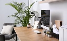 an office with a desk, chair and computer monitor on the table in front of it