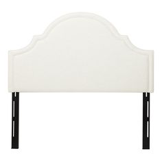 an upholstered headboard with black legs and a white fabric cover on it