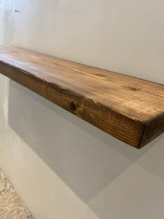 a wooden shelf hanging on the wall