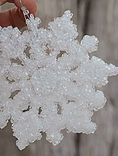 a person is holding some snow flakes in their hand