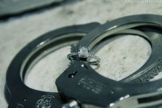 a pair of handcuffs sitting on top of each other with a diamond in the middle