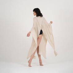 Step up your beach attire with our Elaine Linen Kimono & Beach Cover-Up. Crafted from linen, it's perfect for relaxing or taking a stroll along the shore. The versatile beige color complements any outfit, while the loose fit accommodates most body types.Featuring a stylish V-neck design, long sleeves, and pockets on each side, this kimono offers both style and practicality. With its easy button closure, it's a breeze to slip on over your swimsuit for quick coverage. Whether you're lounging by th Beachwear Cover-up Wrap For Loungewear, Beachwear Wrap Cover-up, Summer White Kimono For Relaxation, White Summer Kimono For Relaxation, Summer Vacation Cream Kimono, Cream Summer Kimono For The Beach, Cream Summer Beach Kimono, Summer Beach Cream Kimono, Cream Wrap Kimono For Summer