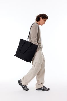 Simply put, this is the perfect everyday bag. Crafted from natural cotton, the Utility Tote combines the clean style of a classic tote bag with effortless function for when you need just a little bit more structure in your life (don’t we all?). Featuring a sleek and seriously timeless north south silhouette and our most-loved features like laptop storage, water bottle pockets, and more, this heavy duty tote is sure to be your new go-to. Everyday Canvas Bag With Double Top Handles, Functional Cotton Bag With Removable Pouch, Functional Cotton Tote Bag, Functional Everyday Canvas Bag With Adjustable Strap, Functional Cotton Bag With Double Handle, Practical Everyday Tote Weekender Bag, Functional Canvas Bag With Adjustable Strap For Everyday, Practical Everyday Weekender Bag Tote, Everyday Versatile Double Handle Canvas Bag