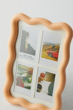 an orange frame with four pictures in it on a white surface and the bottom half is made out of plastic