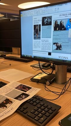 a computer monitor sitting on top of a wooden desk next to a keyboard and mouse