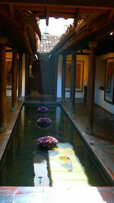 an indoor pool with flowers in the water