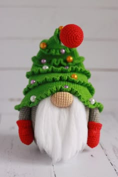 a crocheted gnome with a green christmas tree on it's head and red nose