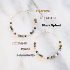 Six ultra-luxe neutral gemstones cover these large gold-filled hoops for a cool wear-with-everything style. Who wouldn't love earrings that take the guesswork out of accessorizing? 45mm (about 1.75") gold-filled hoops with real gemstone beads includes tiger eye, moonstone, black spinel, pink opal, pyrite and labradorite ready for gift giving, packaged on a kraft earring card in a clear resealing sleeve includes earring back for security limited quantities Adjustable Stackable Hoop Earrings For Everyday, Adjustable Stackable Earrings For Everyday, Everyday Adjustable Stackable Earrings, Small Hoop Earrings With Natural Stones For Everyday, Everyday Small Hoop Earrings With Natural Stones, Trendy Natural Stone Jewelry For Everyday, Minimalist Everyday Hoop Earrings With Natural Stones, Everyday Minimalist Hoop Earrings With Natural Stones, Adjustable Stackable Hoop Earrings