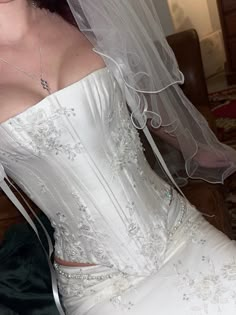 a woman wearing a wedding dress and veil