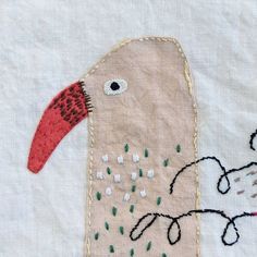 a close up of a piece of fabric with a bird on it's back