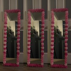 three mirrors that have pink flowers on them