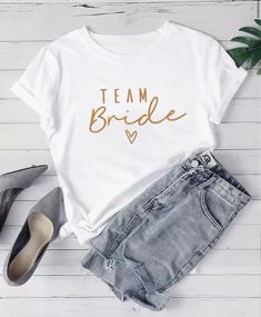 Introducing our Team Bride T-Shirt, specially crafted for Brides and or Bridesmaids. This shirt is: Perfect for bachelorette parties and bridal showers Lightweight and breathable fabric for comfortable wear in warm weather Stylish "Team Bride" print to show off your bridal party pride Versatile design can be dressed up or down for any occasion Great gift for the bride-to-be and her Made from premium quality, breathable cotton, this t-shirt offers maximum comfort while you effortlessly drop sarca Bridal Shower Shirts, Diy Tshirt, Team Bride Shirts, Womens Apparel, Bride Shirts, Team Bride, Bachelorette Parties, T Shirt Diy, Casual Top