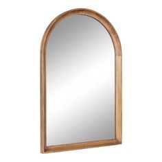 an arched wooden mirror on a white wall