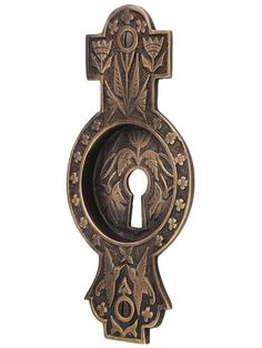 an ornate door handle with a keyhole in the center and floral designs on it