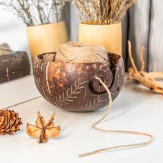 two vases filled with dried plants and twine