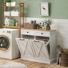 a washer and dryer sitting next to each other in front of a green wall