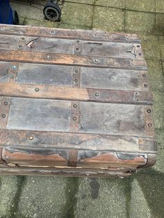 an old wooden box sitting on the ground