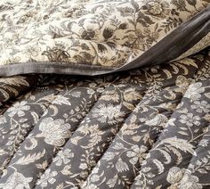 the comforter is made up with black and white floral designs on it's sides