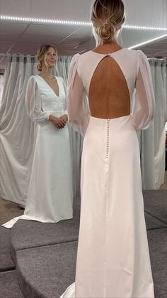 the back of a woman's dress as she stands in front of another woman