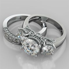 two wedding rings with diamond accents on each one and an engagement ring in the middle