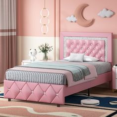 a bedroom with pink walls and furniture in the room, including a bed that is upholstered