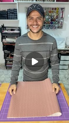 a man standing in front of a cutting board