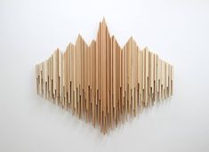 a sculpture made out of wood sticks on a wall