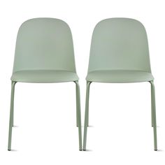 two light green chairs sitting next to each other