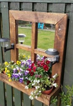 an old window is filled with potted flowers and other things to put in it