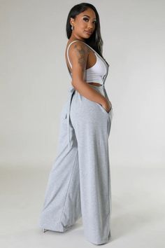 Stay cool, chic, and comfy all day in our Casual Sweatpant Jumpsuit. With a cool suspender-style look and wide legs, this jumpsuit takes casual to the next level. Perfect for everyday wear, you'll never want to take it off. pictured top is not part of the purchase Relaxed Fit Wide Leg Overalls For Loungewear, Wide Leg Relaxed Fit Overalls For Loungewear, Wide Leg Solid Color Jumpsuits And Rompers For Loungewear, Casual Wide Leg Loungewear Overalls, Trendy Wide Leg Jumpsuits And Rompers For Day Out, Casual Wide-leg Overalls For Loungewear, Cotton Wide Leg Overalls For Loungewear, Relaxed Fit Wide Leg Jumpsuit For Day Out, Casual Loungewear Overalls