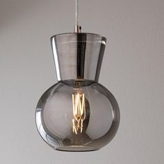 a clear glass light fixture hanging from a ceiling