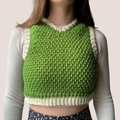 a woman wearing a green knitted sweater