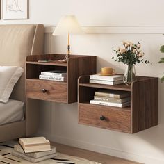 a wooden shelf with two drawers on top of it next to a bed and a lamp