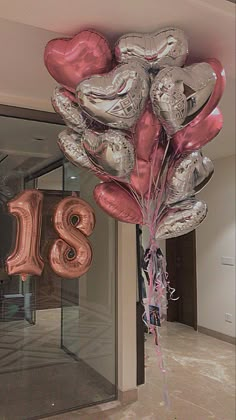 a bunch of balloons that are in the shape of letters and numbers hanging from a ceiling