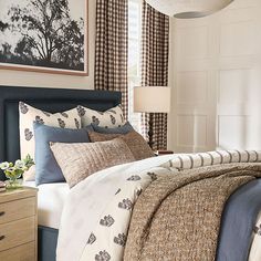 a bed with blue and white comforters in a bedroom