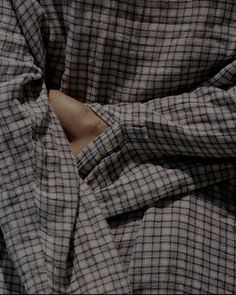 a close up of a person's shirt with their hands in the pocket