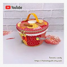 a small red and white basket sitting on top of a table