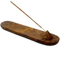 an old wooden object with two needles sticking out of it's end, on a white background