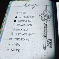 an open notebook with writing on it and a key to do list in the middle