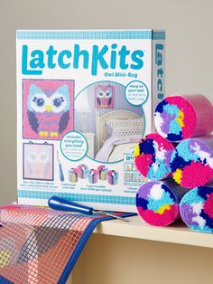 an assortment of crochet kits and toys on a shelf next to a book