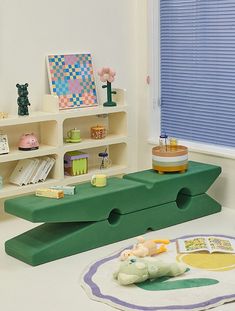 a child's play room with toys and bookshelves