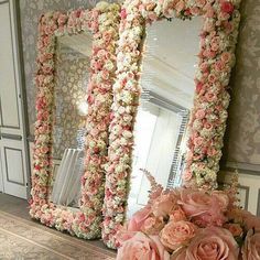 there is a large mirror with flowers on it