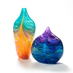 two colorful vases sitting next to each other