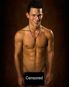 a shirtless man with no shirt on posing for a photo in front of a dark background