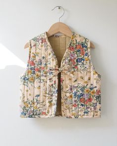 a floral vest hanging on a wall