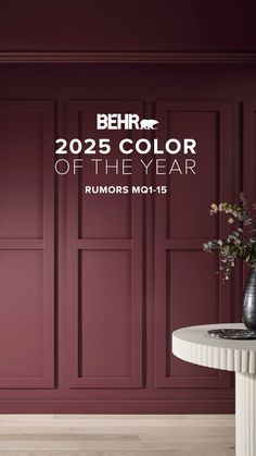 a living room with red walls and white furniture in the center is an advertisement for behrt's color of the year