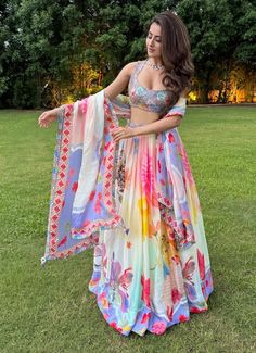 Elevate your wardrobe with the enchanting Summer Bloom Lehenga Set. This exquisite ensemble features a beautifully printed lehenga in luxurious satin organza, adorned with vibrant floral motifs that exude grace and elegance. The set includes a meticulously embroidered blouse that adds a touch of sophistication and glamour. Completing the look is a delicate organza dupatta, featuring matching prints and intricate embroidery along the borders. Perfect for destination weddings, festive celebrations Diwali Lehenga With Digital Print On Georgette, Festival Reception Dupatta With Digital Print, Festival Sets With Digital Print For Reception, Digital Print Sets For Reception And Festivals, Festive Digital Print Georgette Lehenga, Festival Georgette Lehenga With Digital Print, Festival Digital Print Georgette Lehenga, Anarkali Choli With Digital Print For Party, Festive Designer Choli With Digital Print