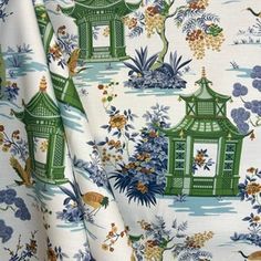 a white and green floral print fabric with pagodas, flowers and birds on it