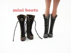 there are two dolls standing next to each other wearing boots with laces on them