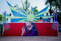 a woman talking on her cell phone in front of a mural